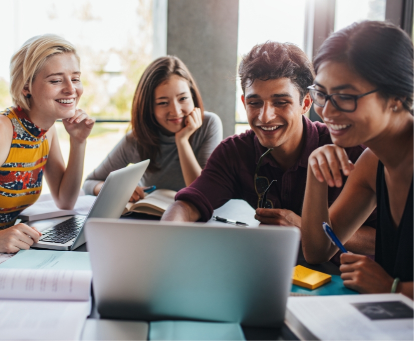 Karriere - Studierende - Gruppe von lachenden Studenten um Laptop